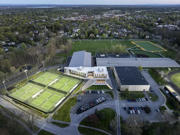 Aerial view of a tennis and athletics complex at dusk